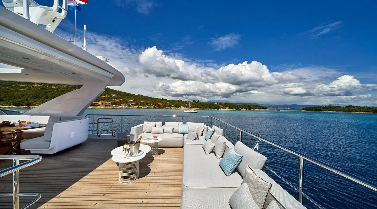 Aluminia Too yacht deck with seating and ocean view under blue sky