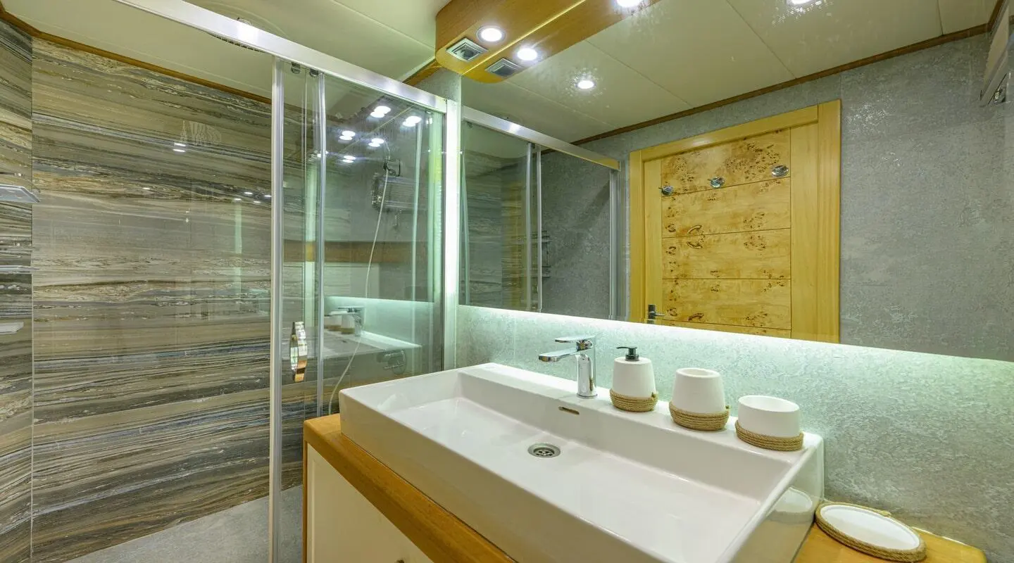 Bathroom of Belgin Sultan gulet with sink, mirrors, and towels
