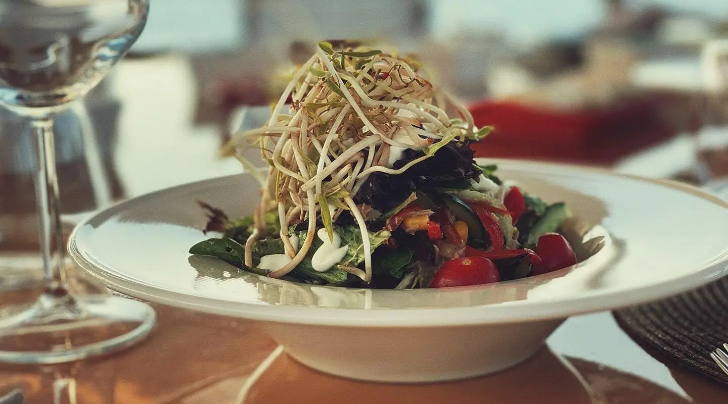 Silver Moon yacht on deck with a gourmet salad plated on white dish