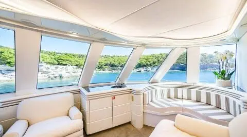 Wind Of Fortune yacht exterior deck with seating and wide windows, calm sea