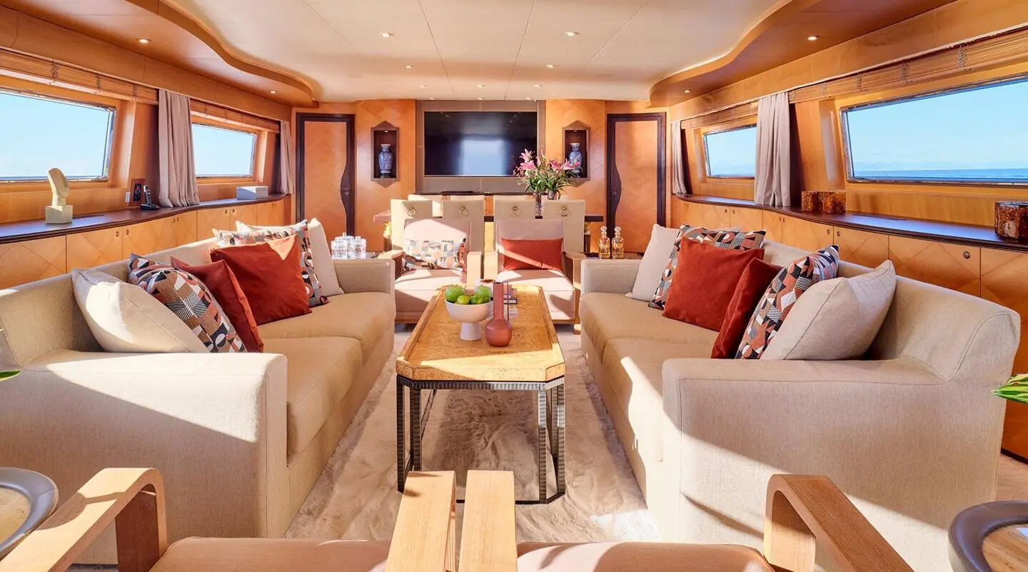 Mobius yacht salon interior with cream sofas, wood tables, and soft lighting