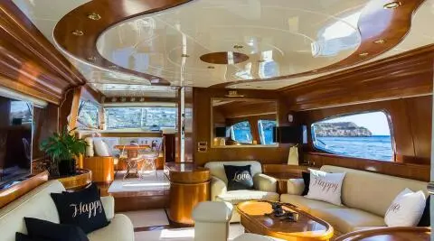 Luxurious yacht Amoraki interior salon with cream seating and wood panels