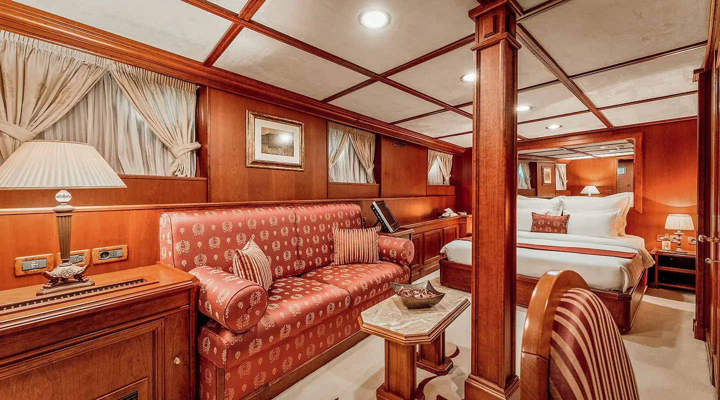 Seagull II yacht interior with red patterned seating and wooden cabin details