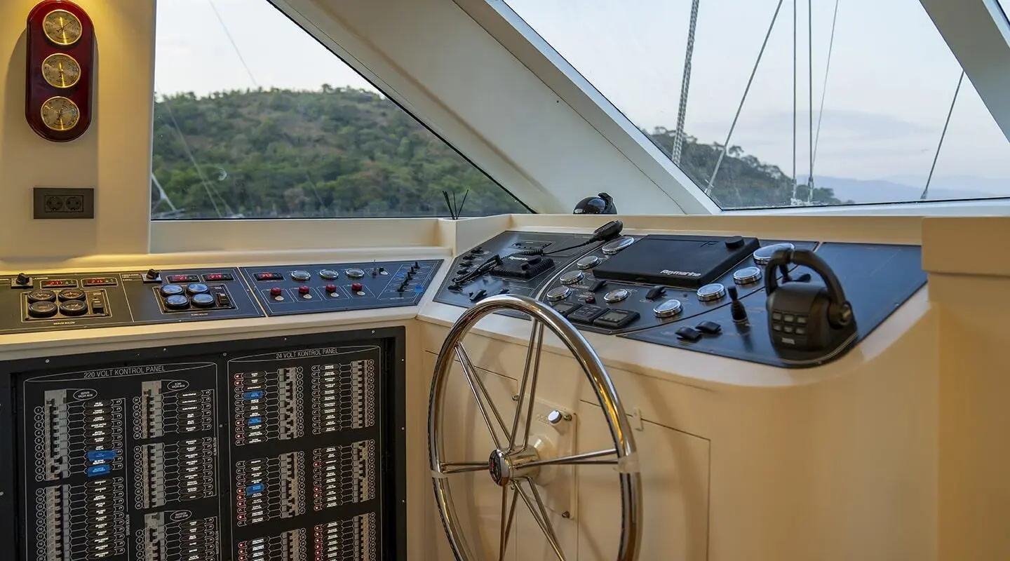 Cockpit of Queen Of Makri luxury yacht with helm wheel and navigation controls