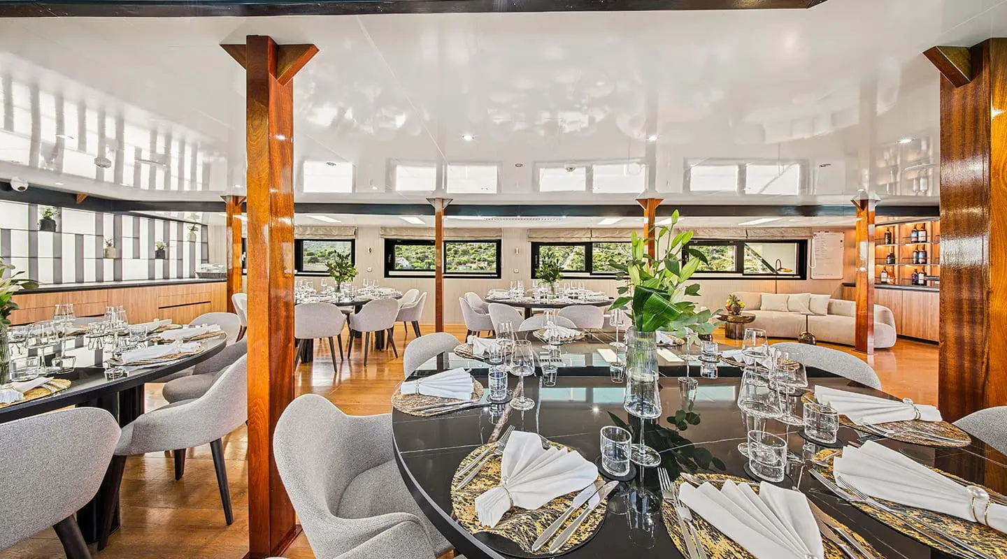 Karizma yacht saloon with sunlit seating area and round table setup
