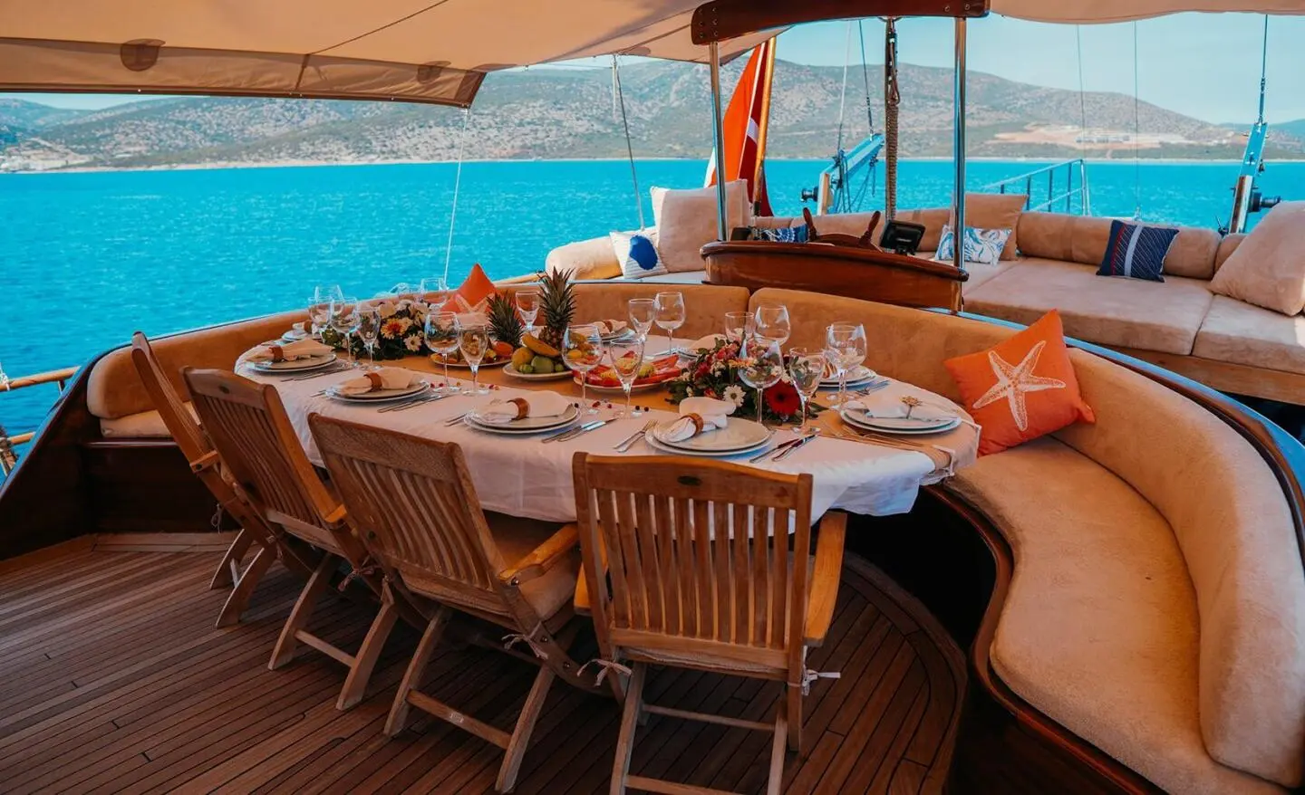 Luxurious yacht deck with a plated dining setup and blue sea view