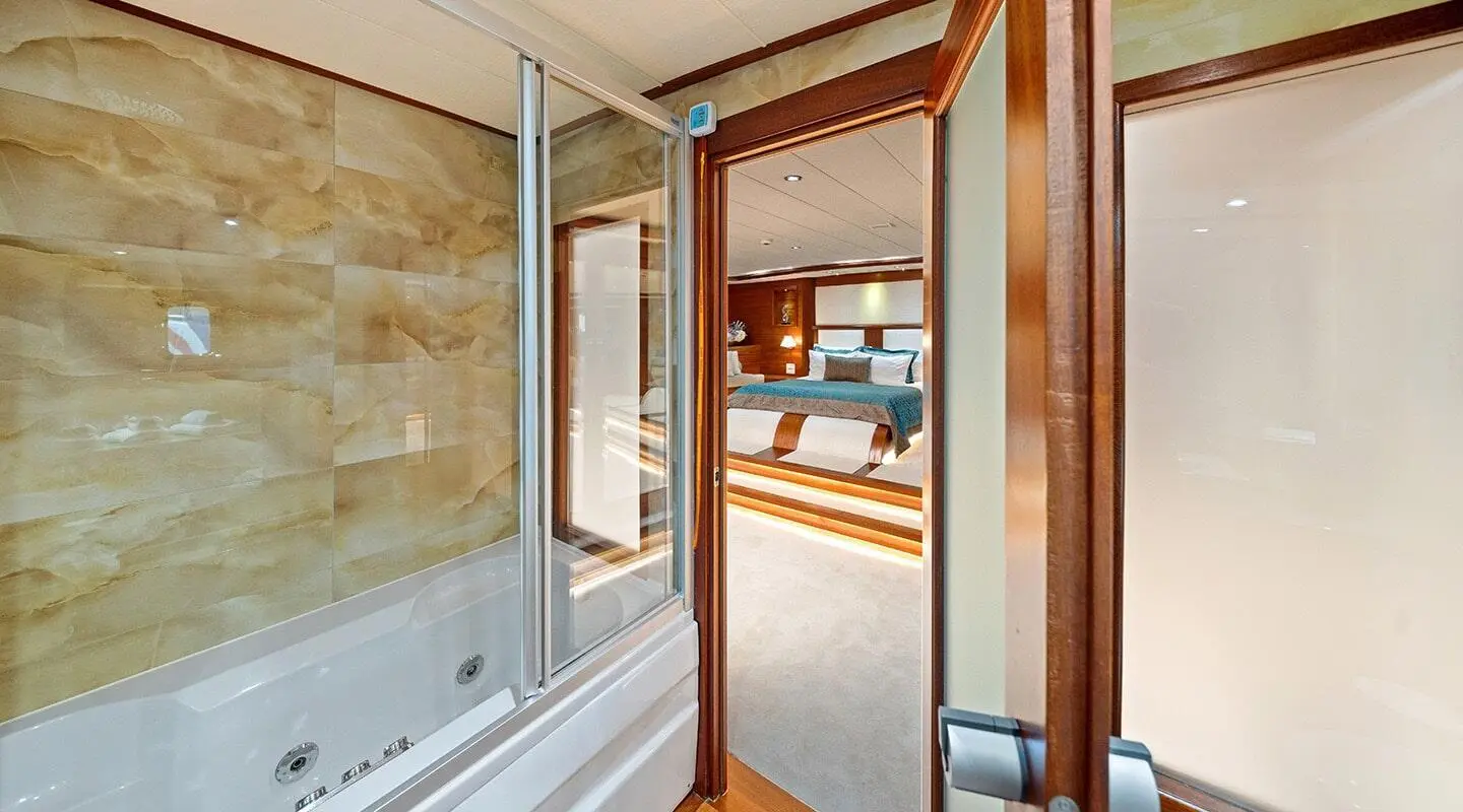 Entrance to a luxury yacht interior with wooden door, exterior water view