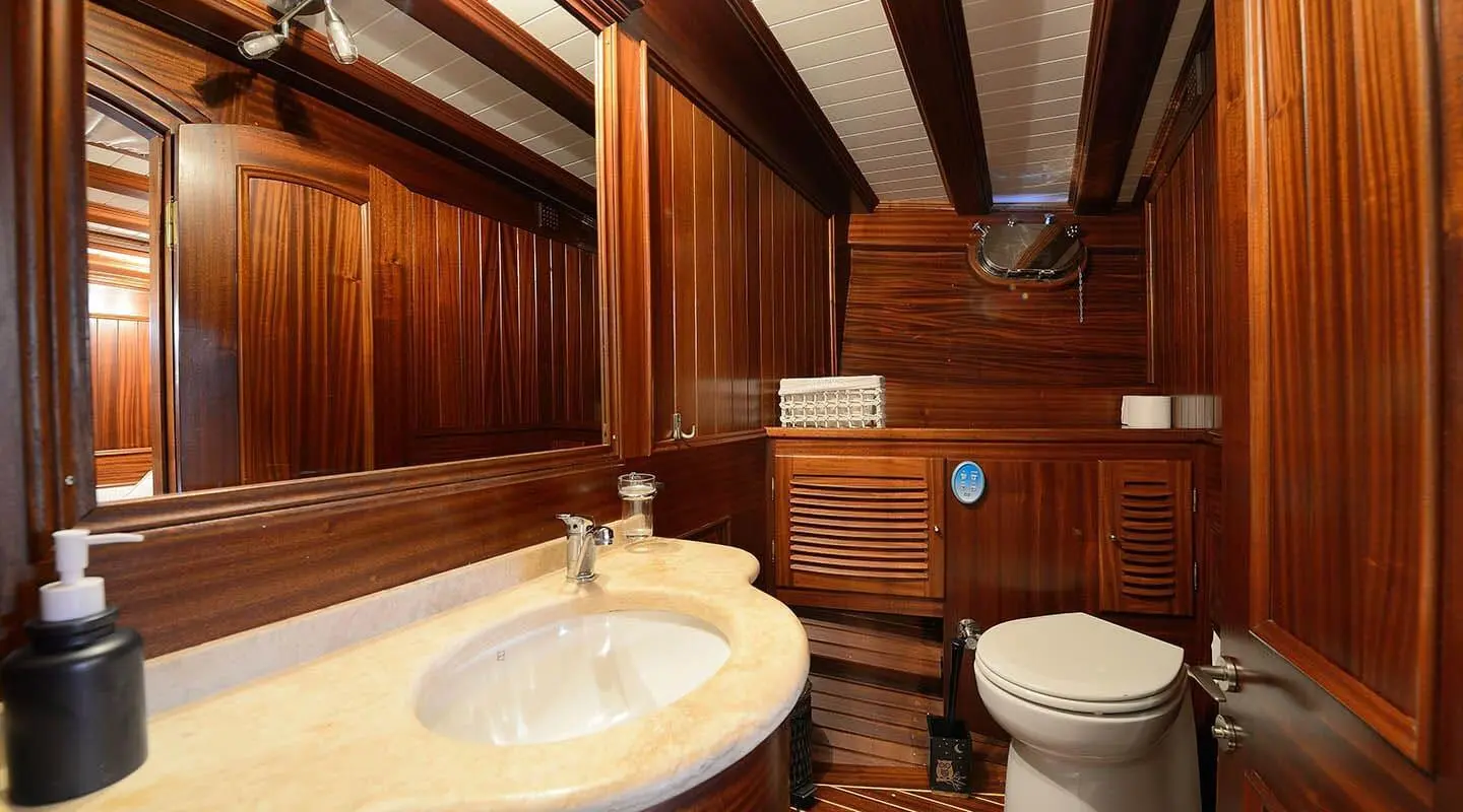Interior view of Zephyria II yacht bathroom with wooden paneling and sink