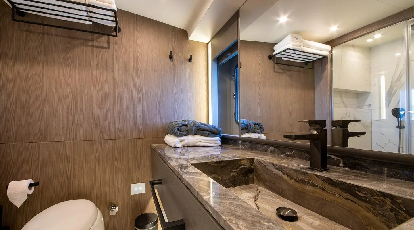Luxury yacht interior with wooden cabinetry, seating, and neutral decor