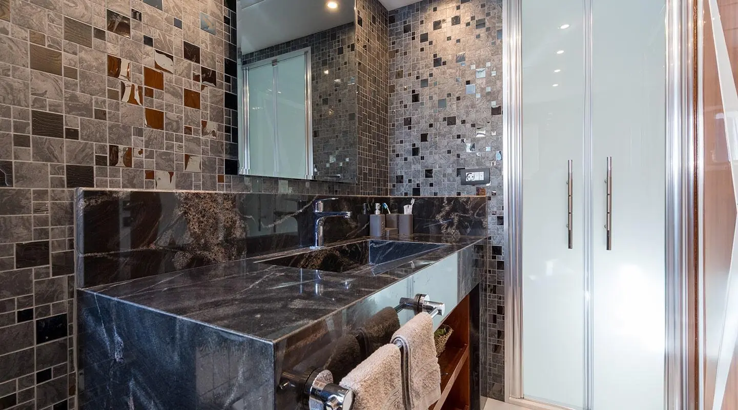 Interior bathroom on gulet Long Island yacht, stone tiles and mirror cabinet