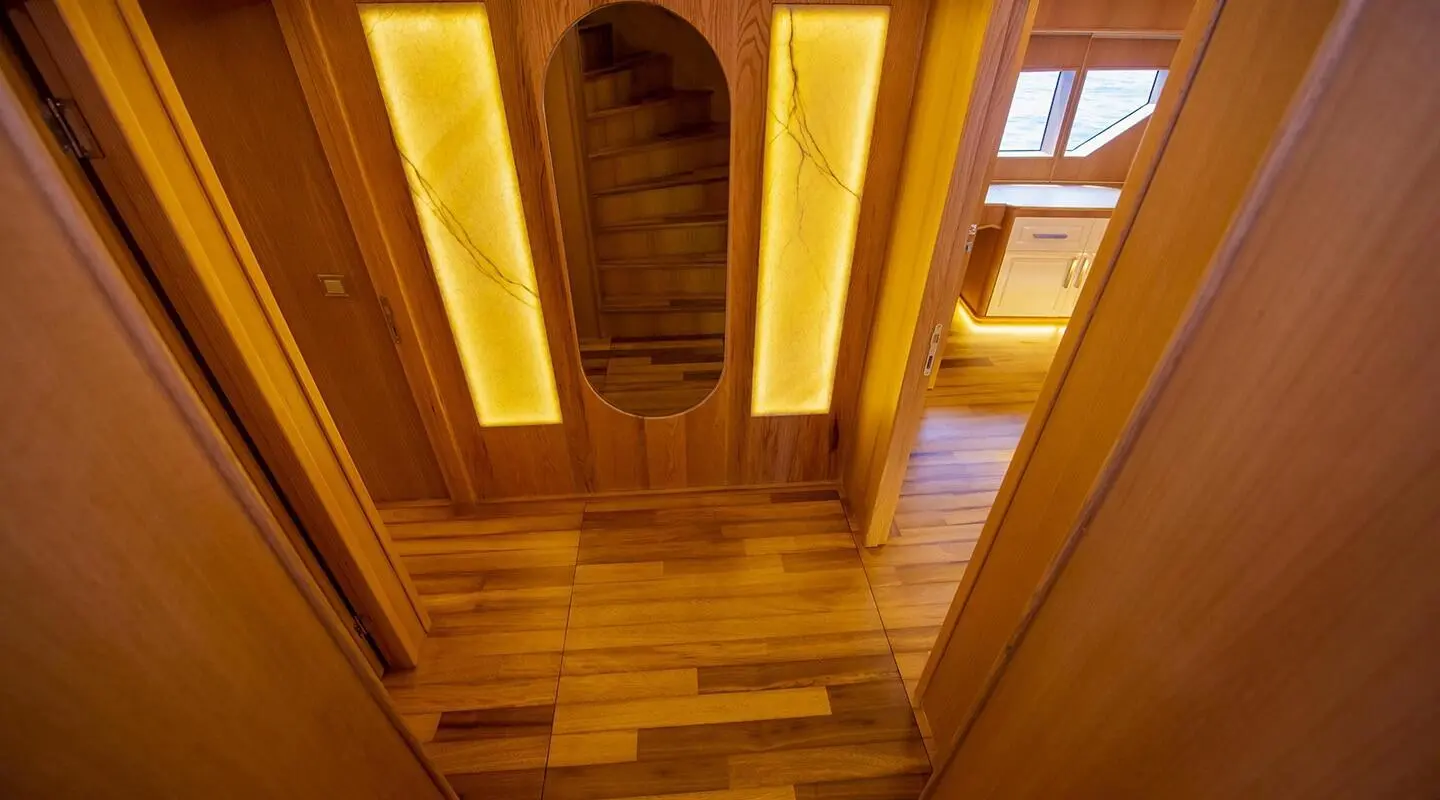 Interior of Simay M yacht hallway with warm wood tones and illuminated panels
