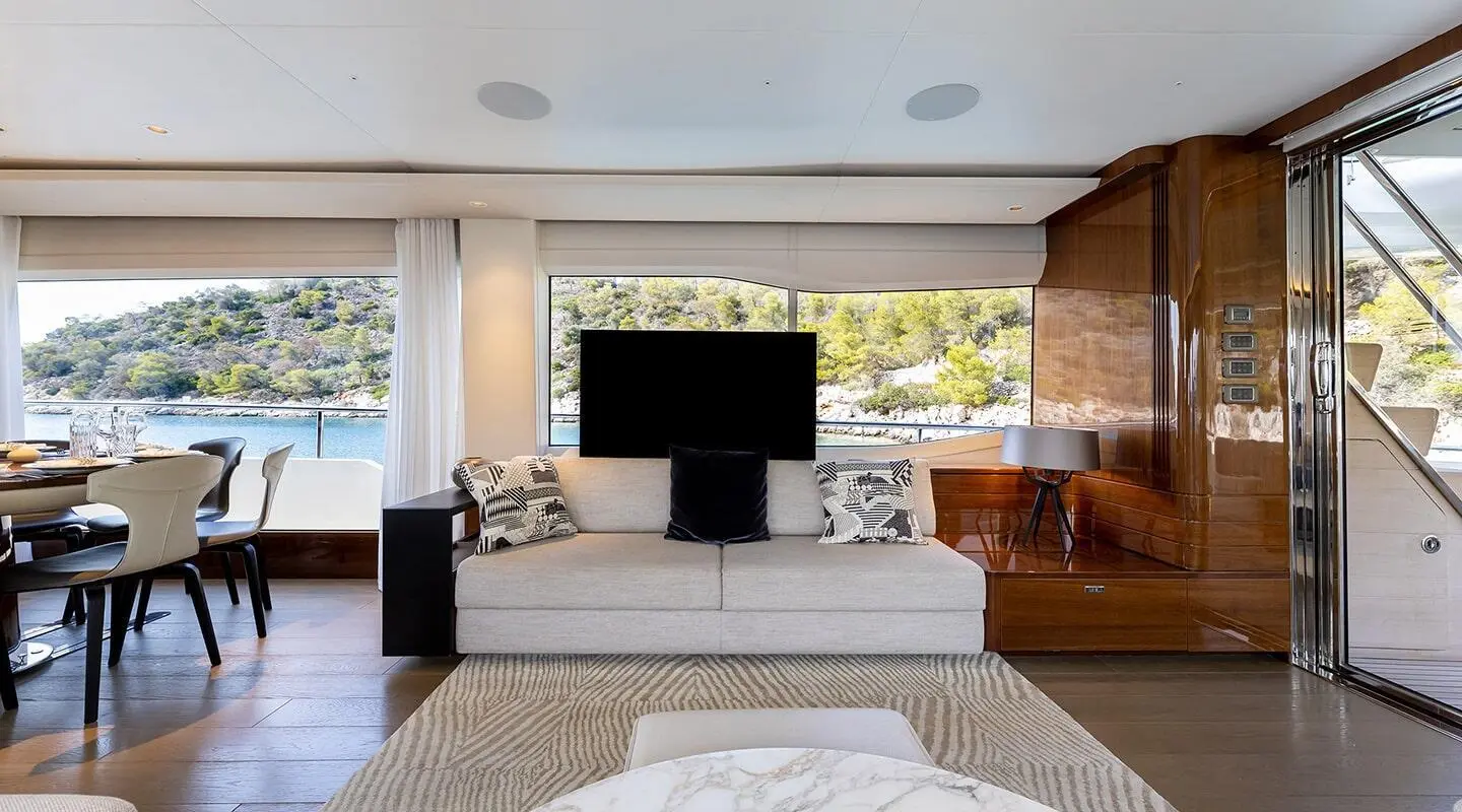 Interior view of Vista yacht lounge with seating, coffee table, and TV