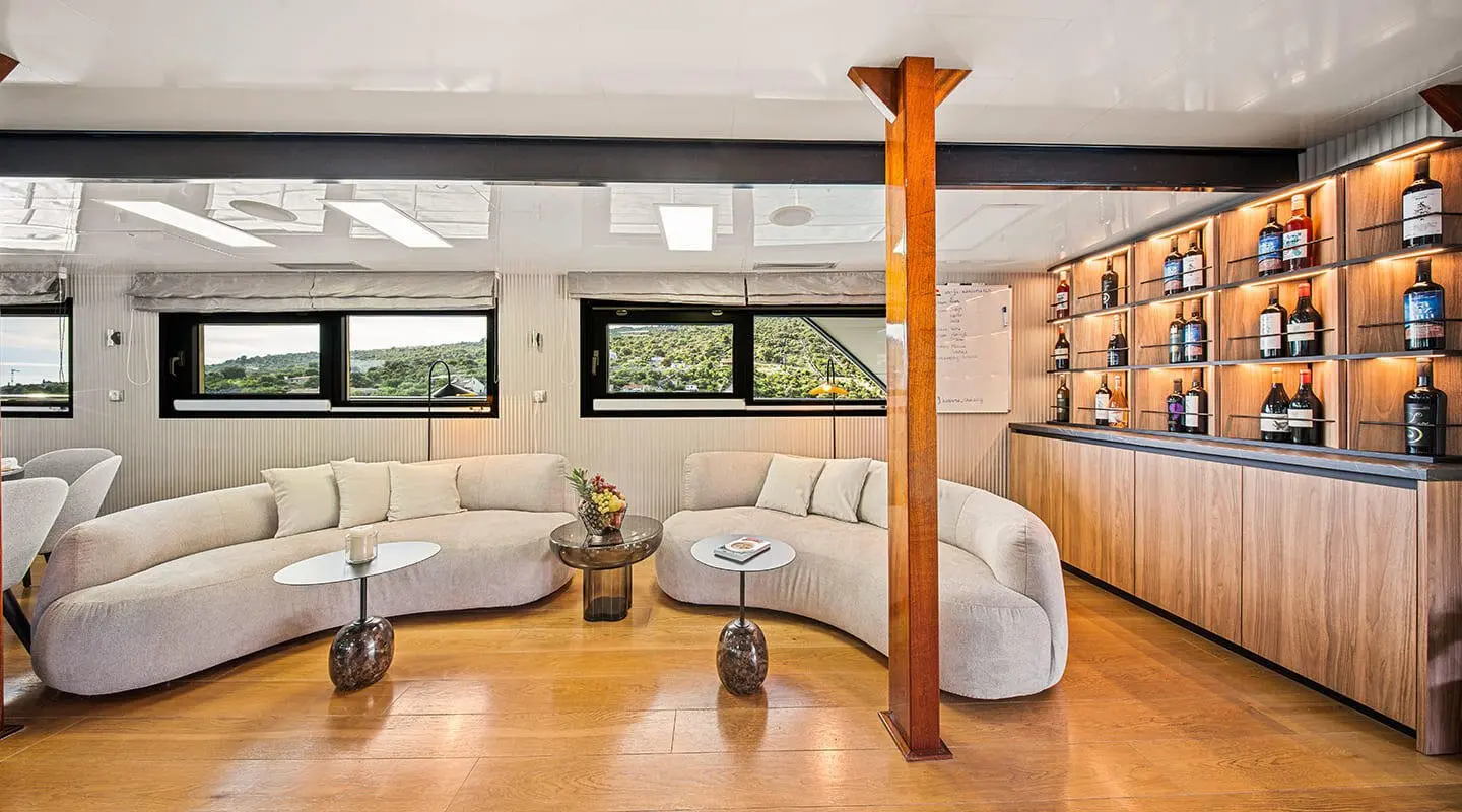Luxe yacht Karizma interior: cream seating, wooden floors, large windows
