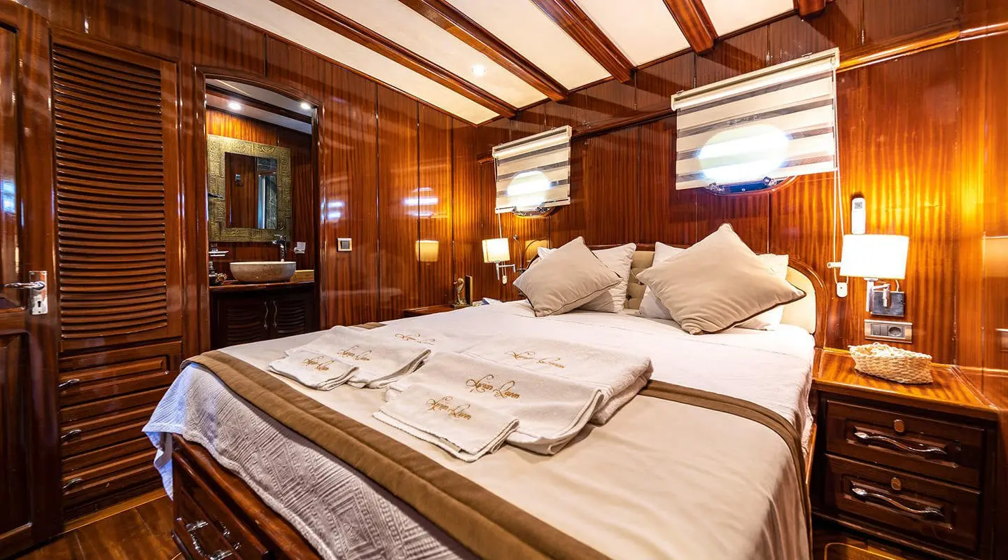 Lycian Queen gulet interior with double cabin, large bed and wood accents