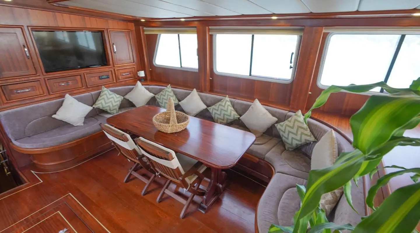 Luxurious yacht Prenses Esila interior with wooden deck and seating around a table