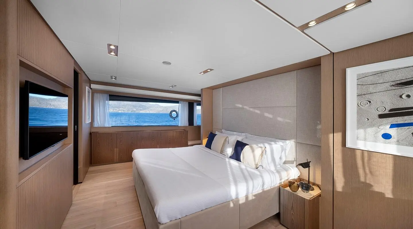 Spica yacht bedroom: two white beds, wooden accents, window view