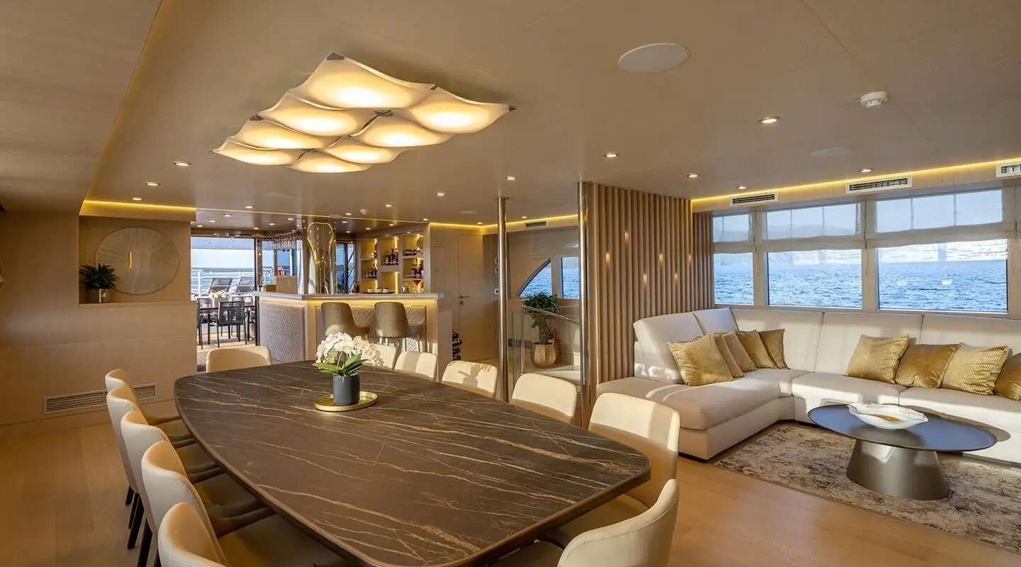 Love Story yacht interior with large bed, seating area, and windows