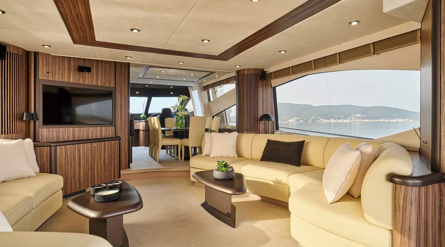Interior of M Five motor yacht saloon with beige seating and wood accents