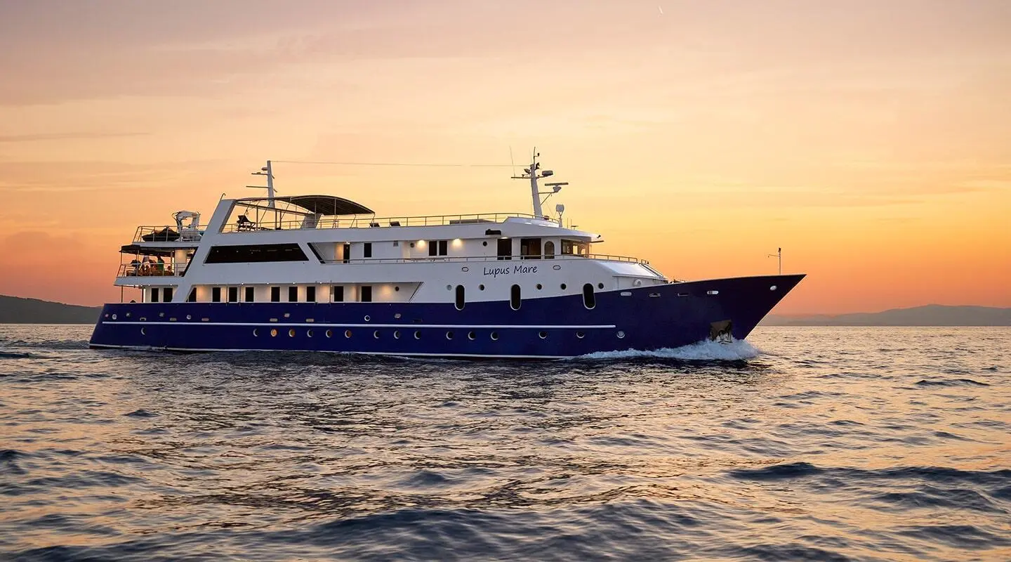 Lupus Mare luxury yacht at sunset on calm water, side profile view