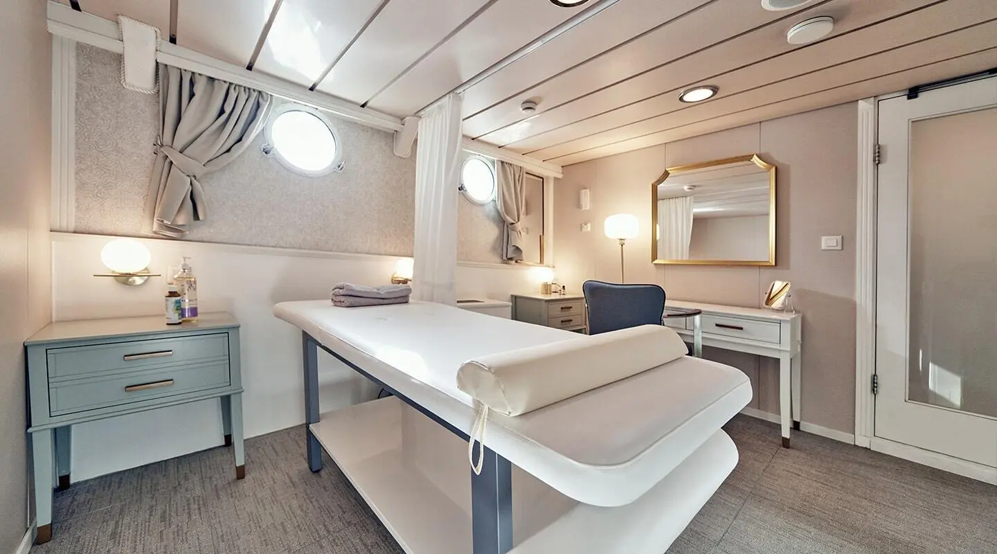 La Perla motor yacht interior with massage room bench seating and soft lighting