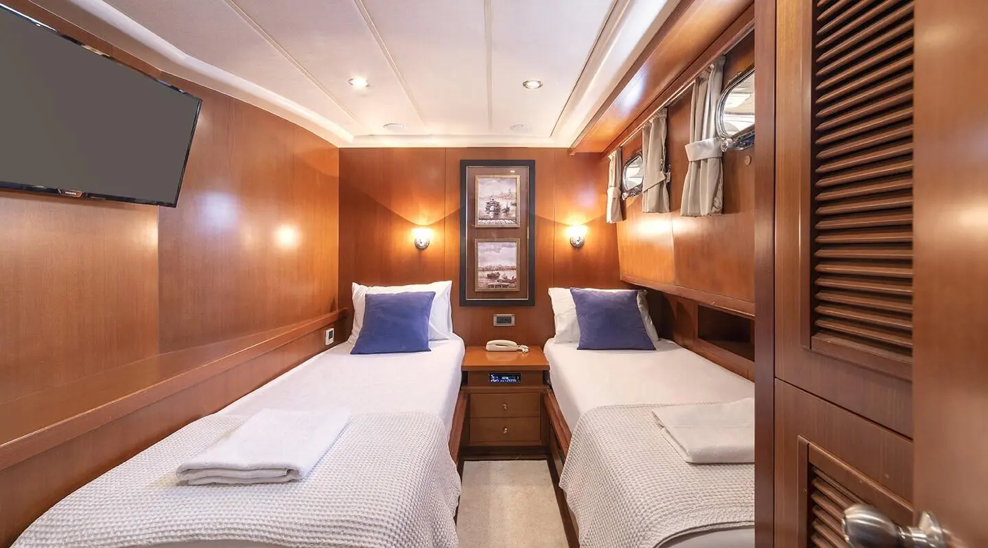 Interior of gulet Arabella with twin cabins, wood paneling, and bunks
