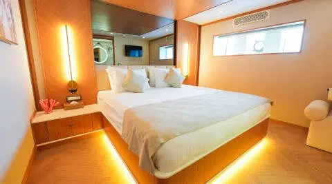 King of the Sea yacht interior with two-queen beds and warm lighting