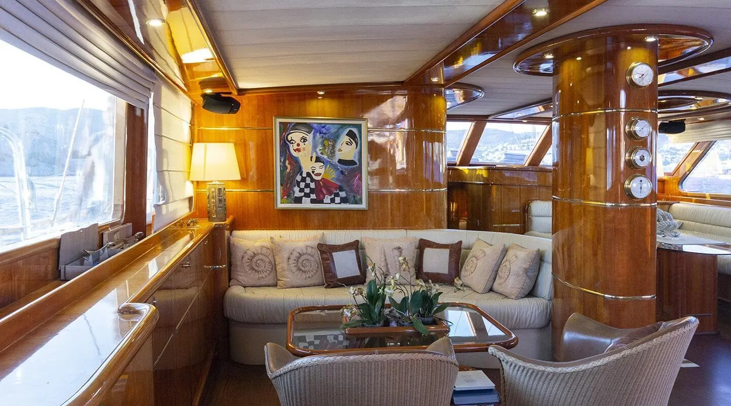 Interior of Silver Moon yacht salon with seating, cushions, and wood paneling