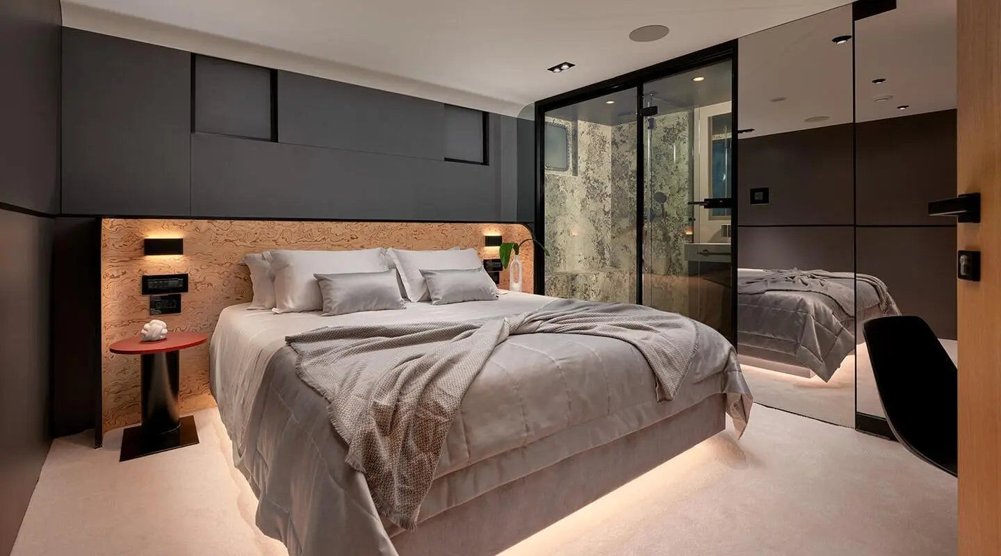 Luxurious yacht Anetta bedroom with large bed, neutral tones, aft window view