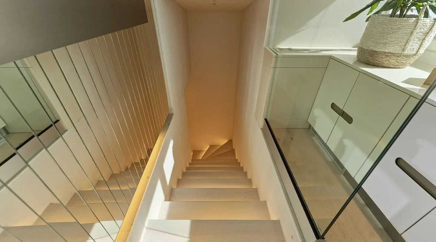 Yacht Maxita interior stairwell view from top to lower deck with wood steps