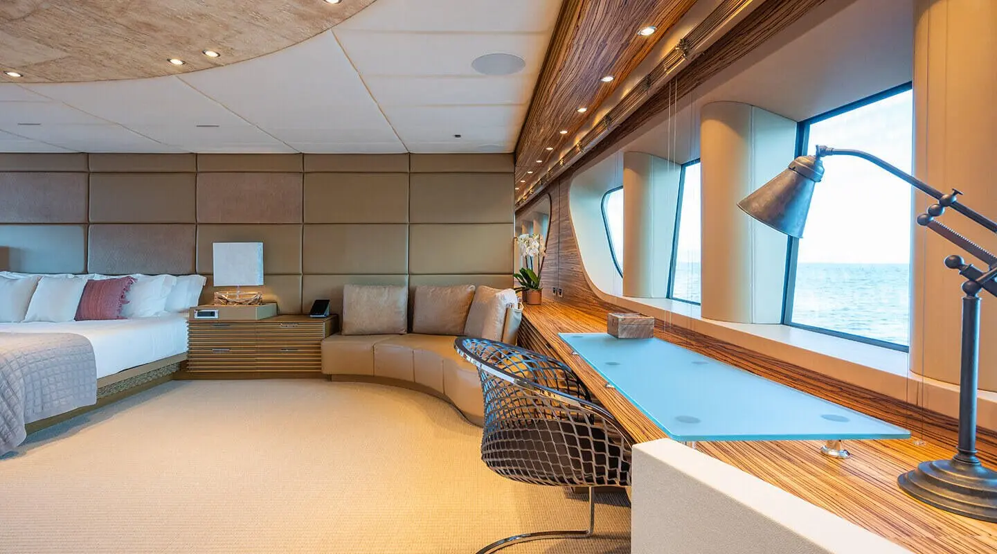 Luxurious yacht Serenity master cabin interior with seating and windows