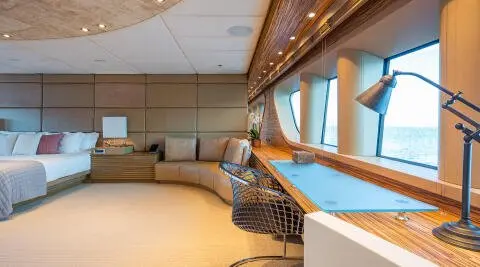 Luxurious yacht Serenity master cabin interior with seating and windows