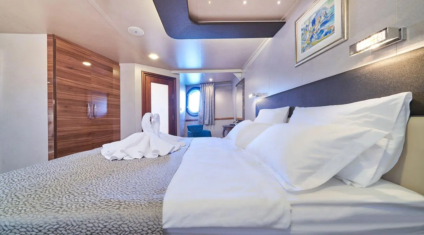 Casablanca yacht master cabin with two large beds and porthole light