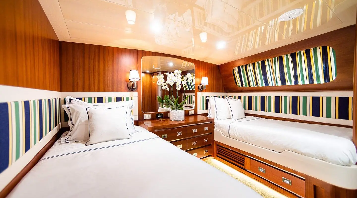 Twin cabin yacht Wind Of Fortune interior with two beds and wood paneling