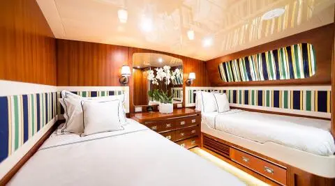 Twin cabin yacht Wind Of Fortune interior with two beds and wood paneling