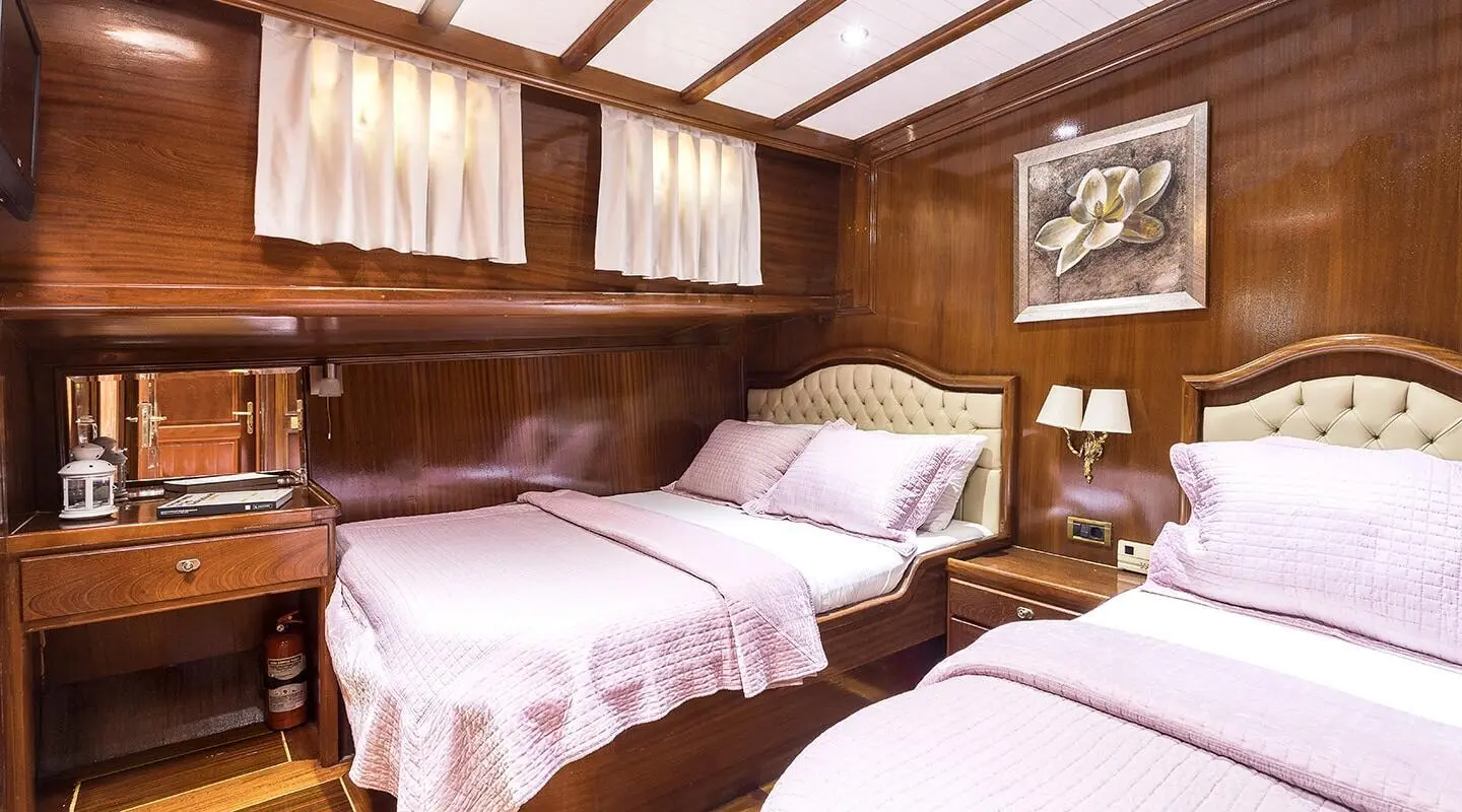 Grace 1 yacht twin cabin interior with two beds and wooden walls