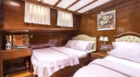 Grace 1 yacht twin cabin interior with two beds and wooden walls
