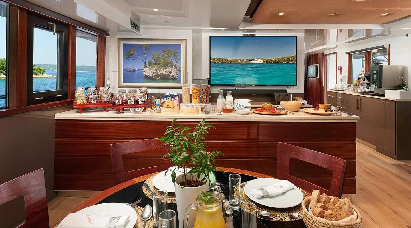 Luxurious interior of Queen Eleganza yacht with dining area and windows