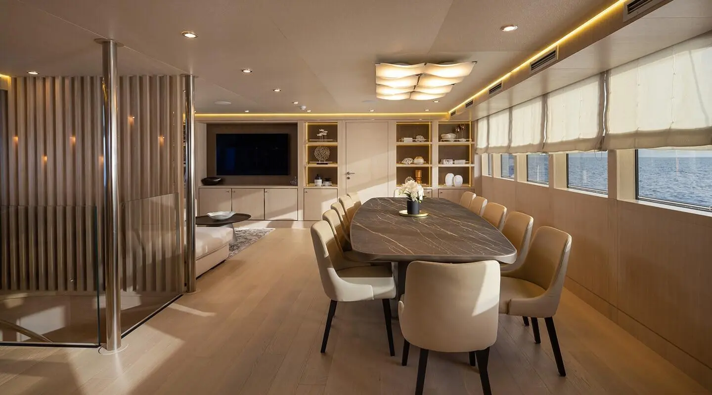 Love Story yacht deck at sunset with seating area and rope railings