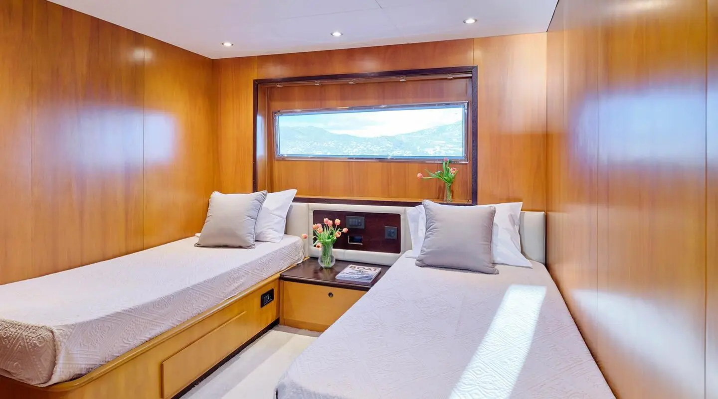 Mobius yacht interior: twin cabin with seating area and large window