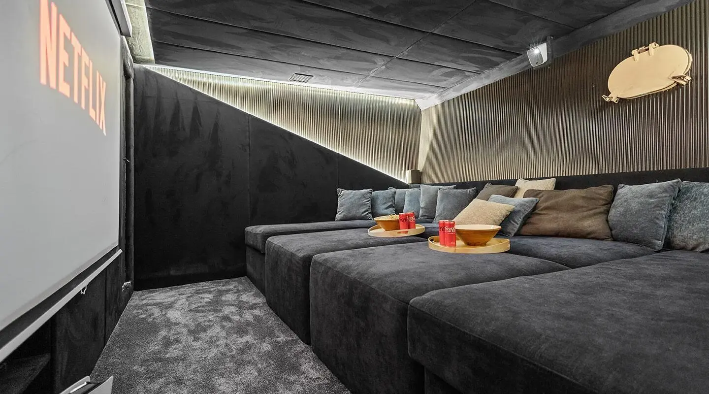 Bella yacht deck lounge area with dark stone walls and red and beige seats