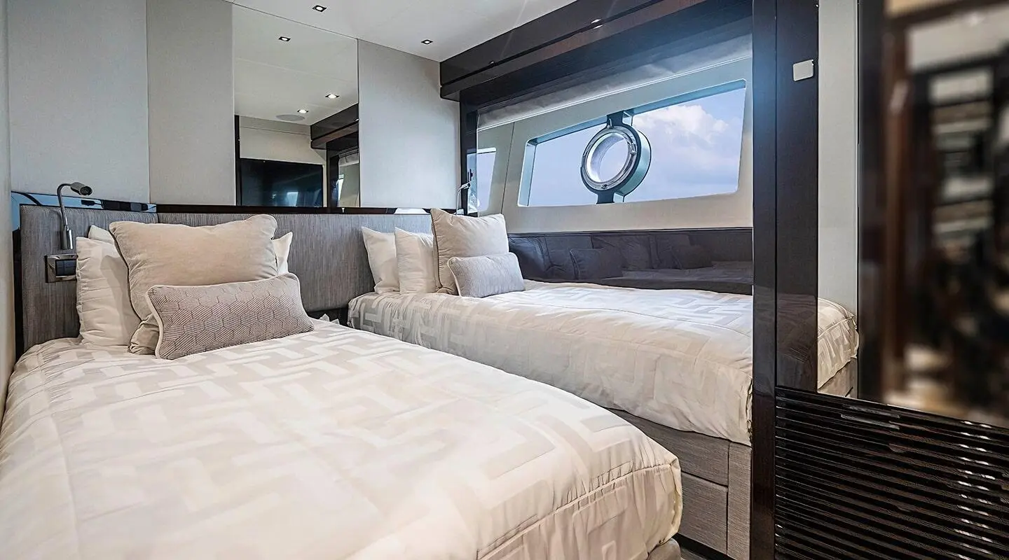 Yacht Quantum interior: twin cabin with two single beds and beige bedding