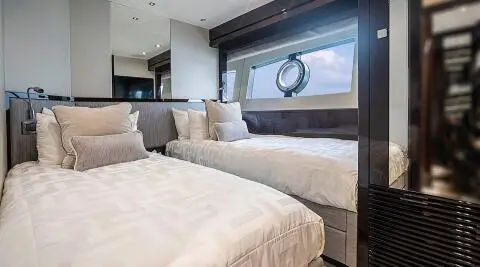 Yacht Quantum interior: twin cabin with two single beds and beige bedding