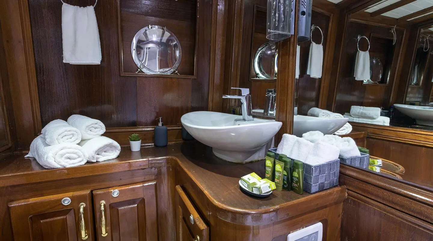 Grace 1 luxury gulet yacht interior with wooden cabinetry and polished sink area