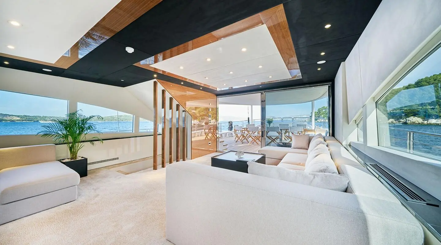 Acapella motor yacht saloon; spacious interior with white furniture and ocean view