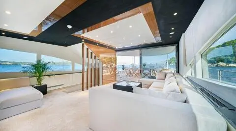 Acapella motor yacht saloon; spacious interior with white furniture and ocean view