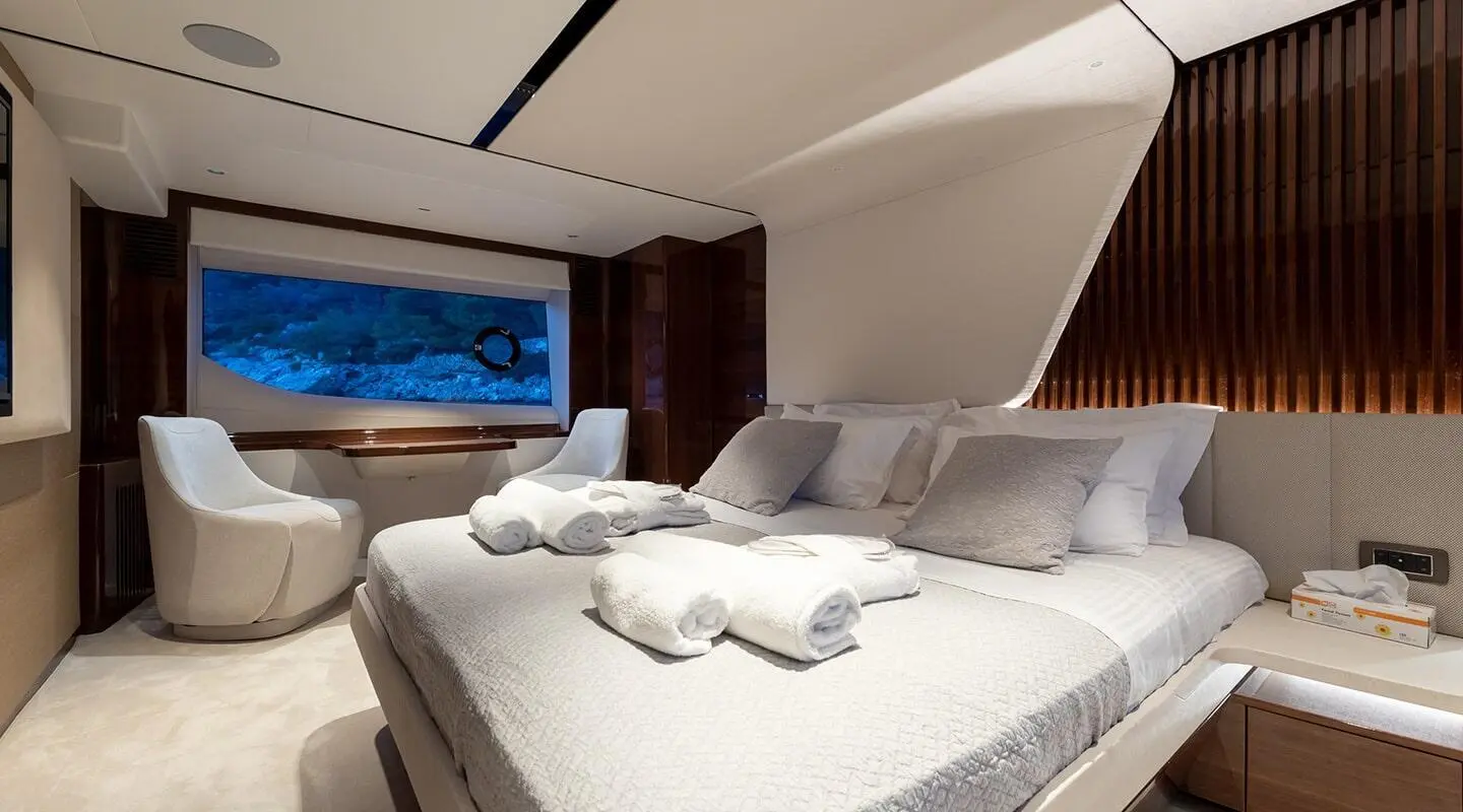 Interior of Vista yacht stateroom with neatly arranged bed and pillows