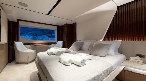 Interior of Vista yacht stateroom with neatly arranged bed and pillows