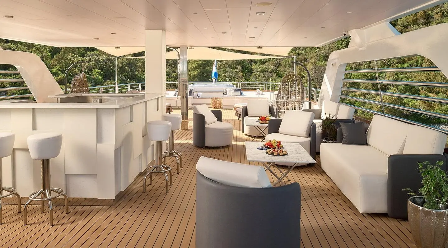 Luxurious yacht Cristal deck lounge area at sunset with seating and open view