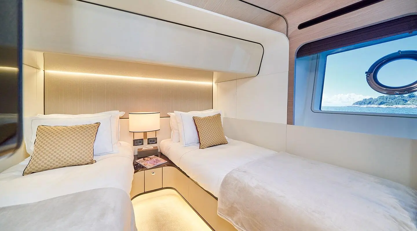 Interior of Aluminia Too yacht: twin cabin with two single beds and overhead storage