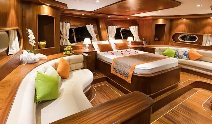 Interior cabin of Gulet Vista Mare with wooden furnishings and beds